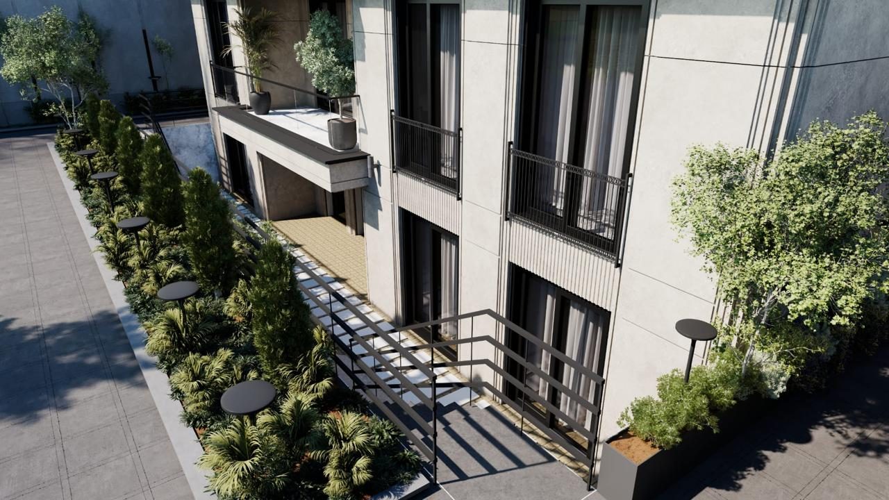 Multi-storey elevation with balconies above a planted walkway
