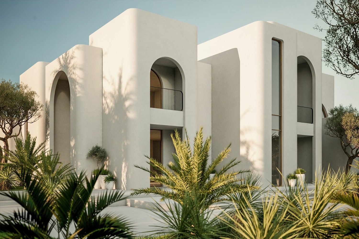 Rounded white-rendered façade with tall arched openings