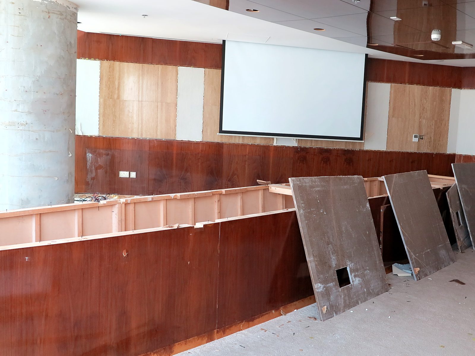 The original boardroom in dated timber panelling, partly stripped