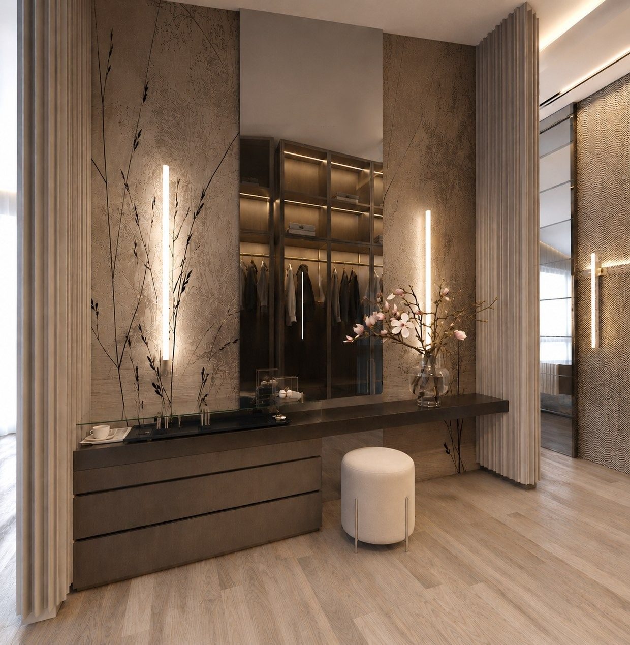 Dressing area with a backlit stone wall and open wardrobes